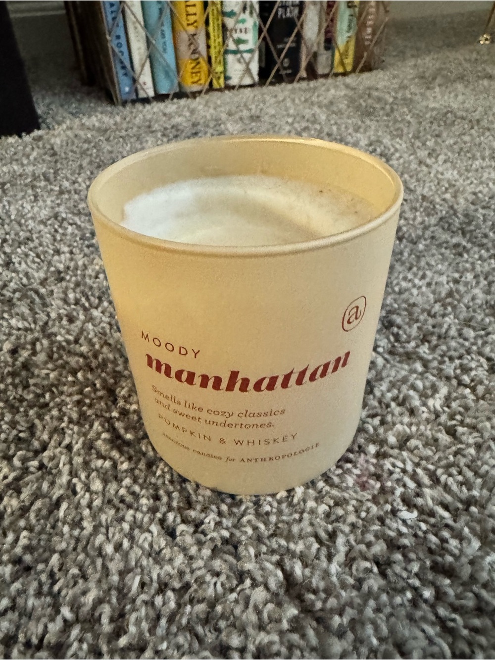 Anthropologie Moody Manhattan Candle in Cream with deep Red Text